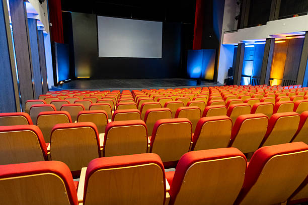 istock Comfortable seating in a modern auditorium with a large screen ready for a presentation or event 2213097788