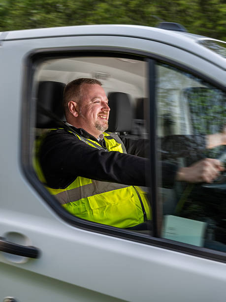 istock Van Driver Smiling while in Motion Wearing High-Visibility Vest 2213100040