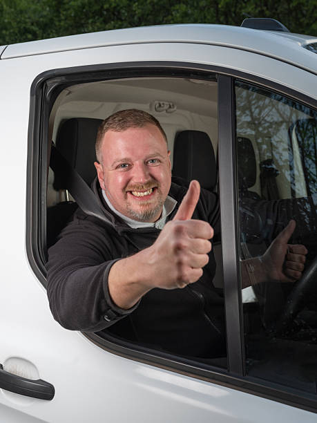 istock Happy Van Driver Giving Thumbs-Up in Motion 2213100085