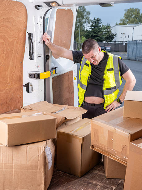 istock Overwhelmed Delivery Driver with Parcels in Van 2213101816