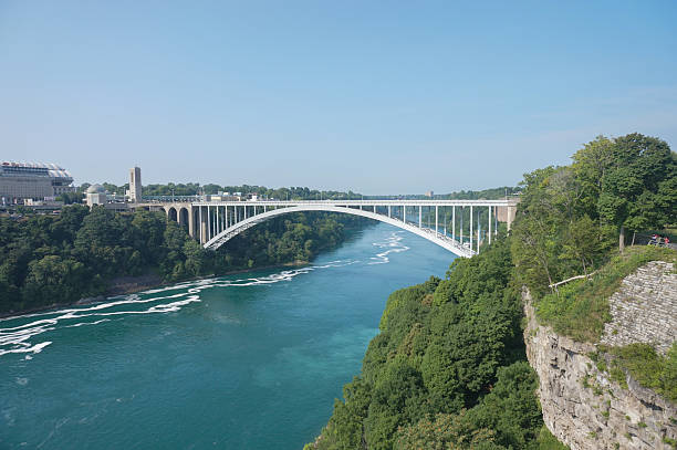 istock A bridge spans a river with a green forest on the other side 2213111244