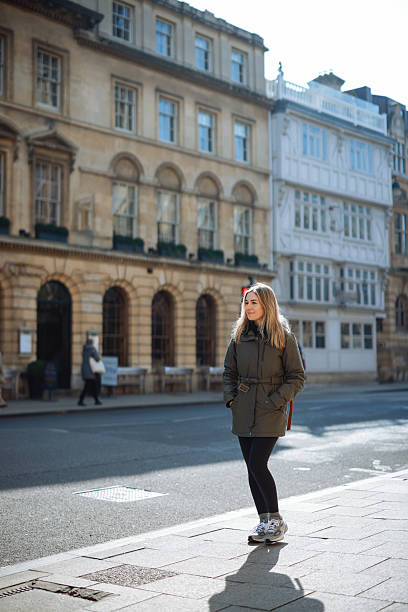 istock Young Woman Walking along Oxford, UK 2213114959