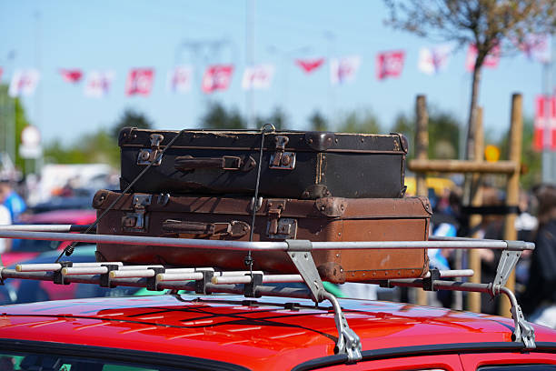 Brown leather retro suitcases closeup on top car
