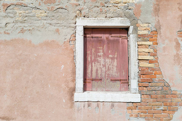 istock Old Brick Wall with Weathered Shuttered Window 2213116781