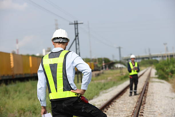 istock Two male logistics engineers are working at the Container railway yard. Cargo port storage for transportation and trading in the rail shipping yard 2213118910