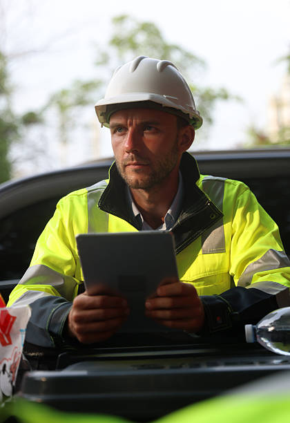 istock Portrait of a Professional construction worker wearing protective light green reflective safety gear, standing confidently at the expansive building site with a determined expression 2213121192