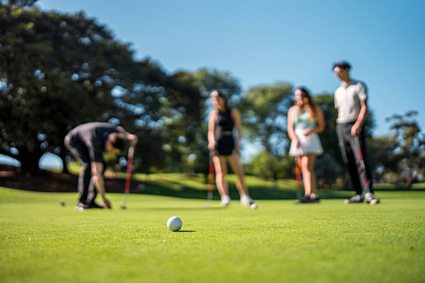 istock Diverse Group Enjoys Engaging Golf Game Outdoors 2213123068