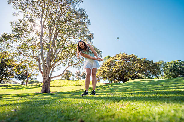 istock Caucasian Female Golfer Joyfully Swinging on Sunny Course 2213123076