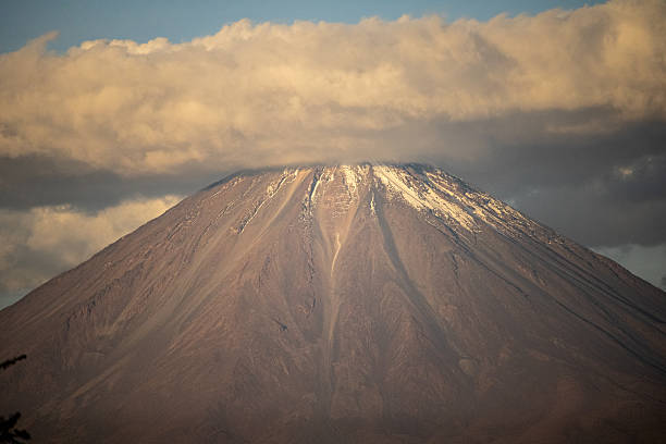 The pointed peak of Licancabur Volcano cuts through desert clouds in this striking view of Chile’s Atacama region.
