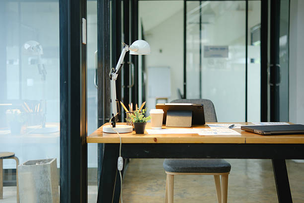 istock Modern office desk with tablet, financial documents, and coffee cup in a professional workspace 2213129761