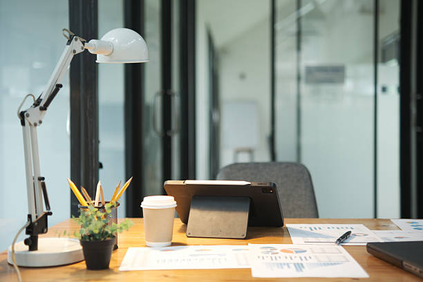 istock Modern office desk with tablet, financial documents, and coffee cup in a professional workspace 2213129762