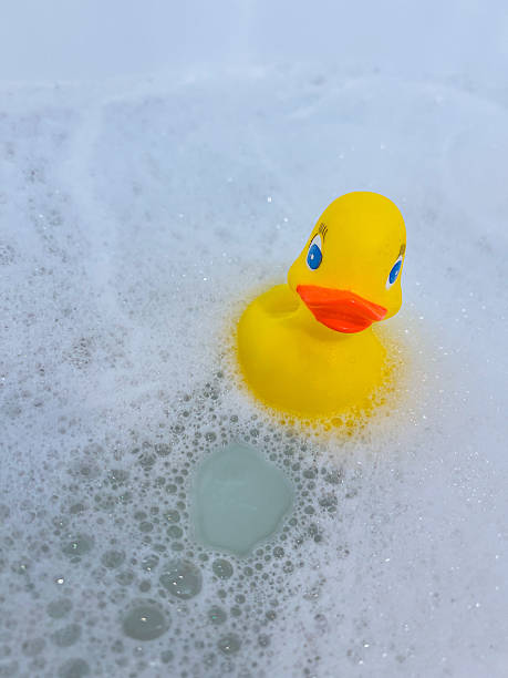 istock Yellow rubber duck in a bubble bath 2213131178