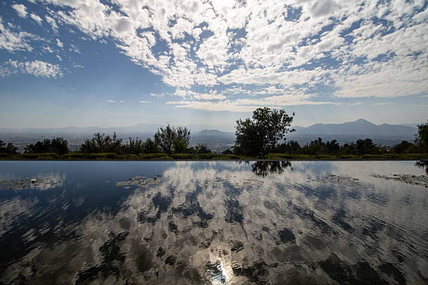 An artificial lake near Santiago mirrors the clear blue sky, offering a calm moment amid the urban landscape of Chile.