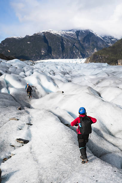 istock Tourists walking on a glacier in the mountains 2213135555