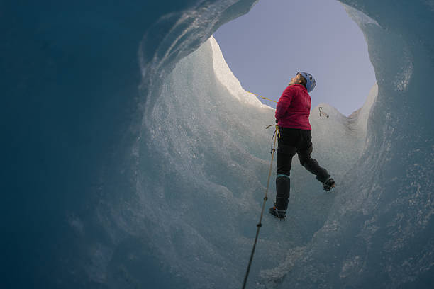 istock Mountaineer ascending a glacier crevasse using rope and crampons 2213137892