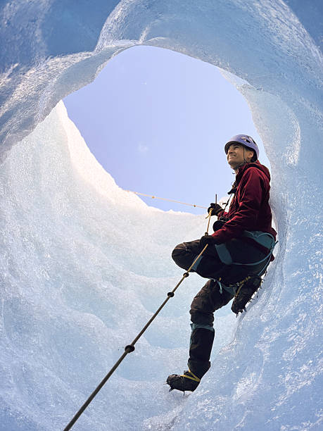 istock Mountaineer ascending ice wall in glacier crevasse 2213138375
