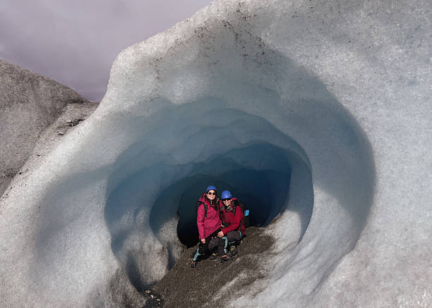 istock Hikers exploring a majestic ice cave in a glacier 2213138770