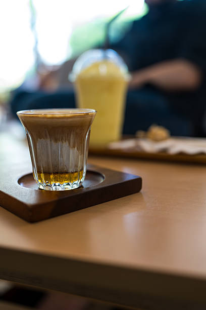 Double dirty coffee cup, espresso coffee with milk and honey