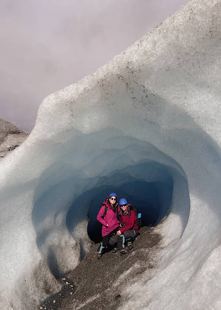 istock Hikers exploring ice cave in breathtaking glacier landscape 2213139184