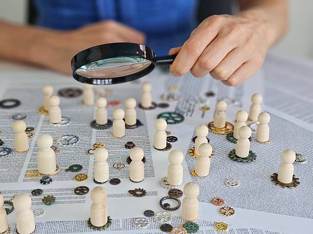 istock Investigation of teamwork dynamics using wooden figures and gears during a strategic planning session concept 2213142794
