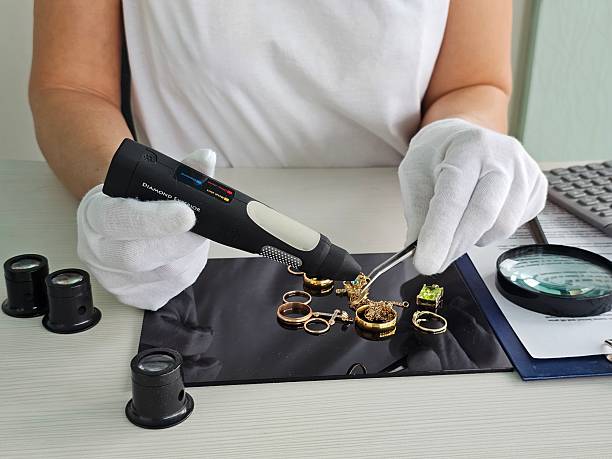 istock Jewelry inspection process with a diamond tester and tools on a workspace concept 2213143143
