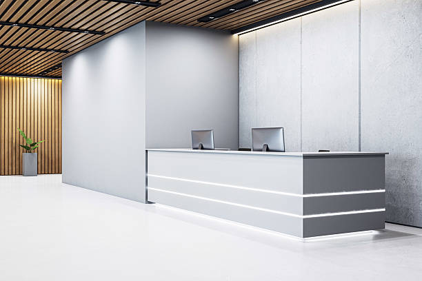 istock Modern minimalistic reception desk with computers in stylish corporate office interior with wooden ceiling and concrete wall background. 3D Rendering. 3D Rendering 2213146205
