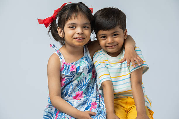 istock Sister and brother against white background 2213149739