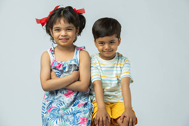 istock Sister and brother against white background 2213149796