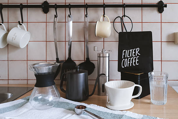 Ingredients and equipment for making coffee. Different ways to make alternative coffee - ceramic V60, glass Chemex, small teapot for brewing coffee, manual coffee grinder. Kitchen at home