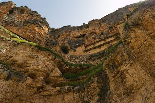 istock Majestic cliffs rise steeply under clear blue sky in natural landscape during bright daylight 2213154821