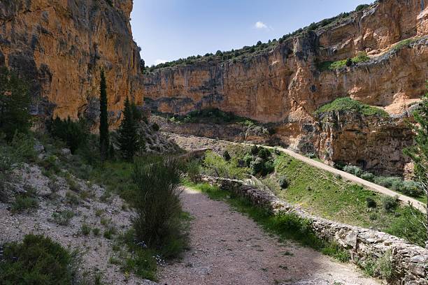 istock Scenic view of a winding path through dramatic cliffs in a natural landscape during bright daylight 2213154839
