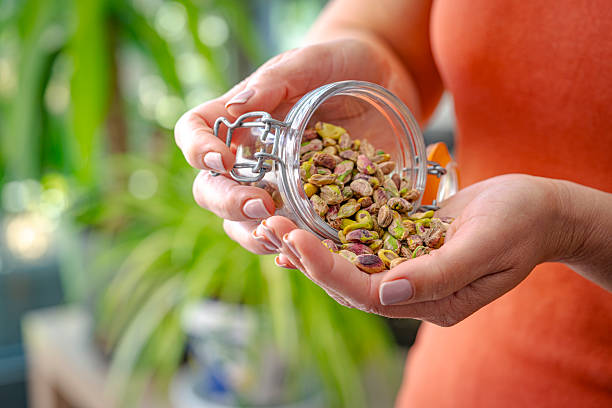 istock Woman eating fresh organic pistachios 2213158013