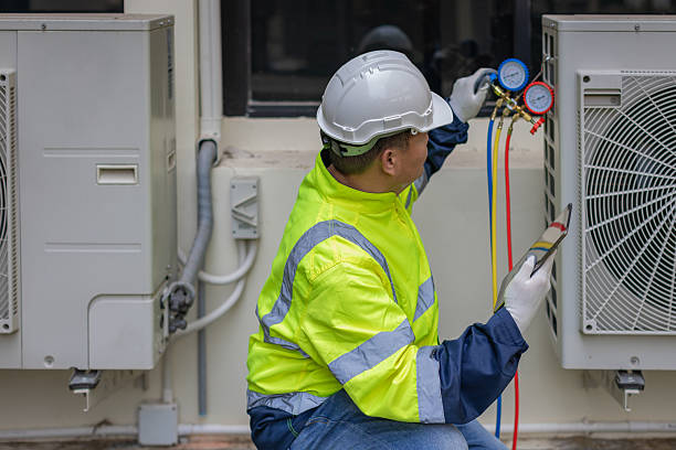 istock Technician is checking air conditioner. Air conditioning, HVAC service technician using gauges to check refrigerant and add refrigerant. 2213160458