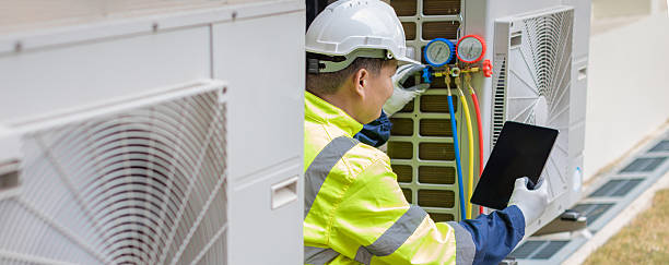 istock Technician is checking air conditioner. Air conditioning, HVAC service technician using gauges to check refrigerant and add refrigerant. 2213160459