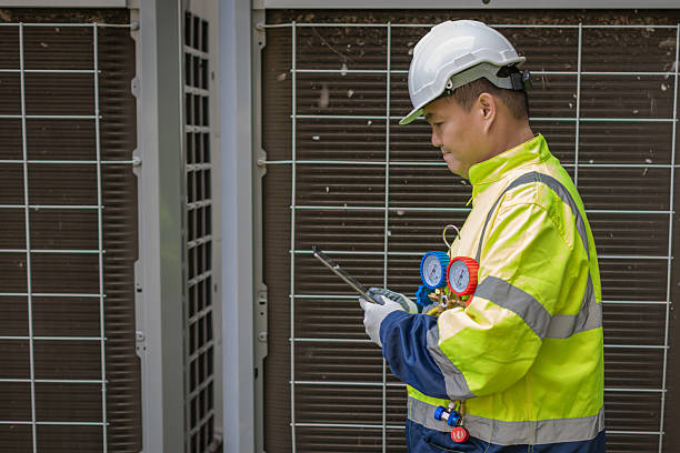 istock Technician is checking air conditioner. Air conditioning, HVAC service technician using gauges to check refrigerant and add refrigerant. 2213160473