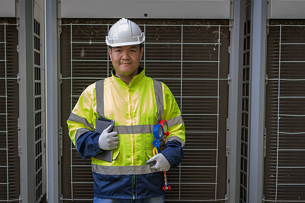 istock Technician is checking air conditioner. Air conditioning, HVAC service technician using gauges to check refrigerant and add refrigerant. 2213160477
