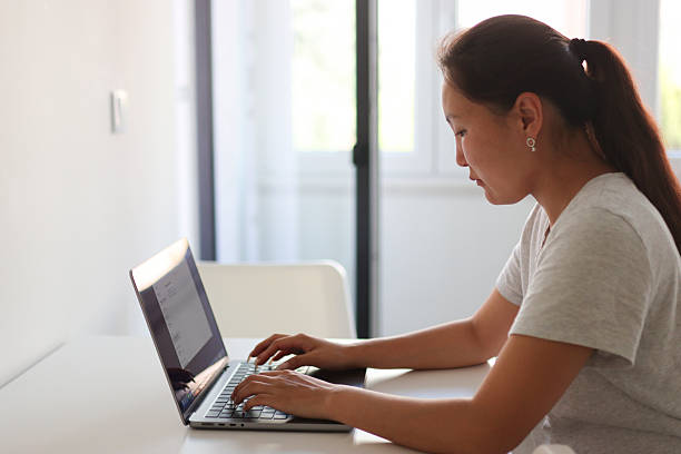 istock Asian freelancer working on laptop at home office 2213163106