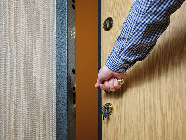 istock A man locks or opens the front door from the inside when entering his house or apartment. 2213163377
