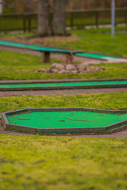 istock miniature golf course with worn green turf.. 2213163930