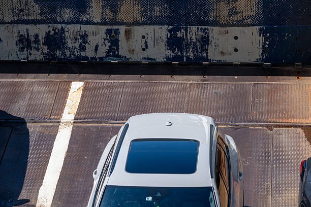 istock overhead view of white car on metal ferry deck.. 2213164319