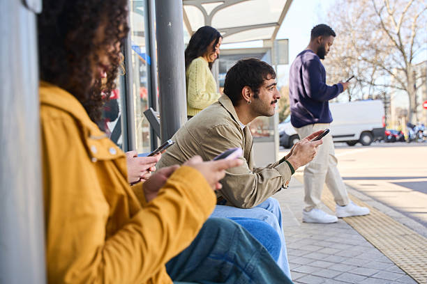 istock multiethnic people using smartphones while waiting at bus stop 2213164344