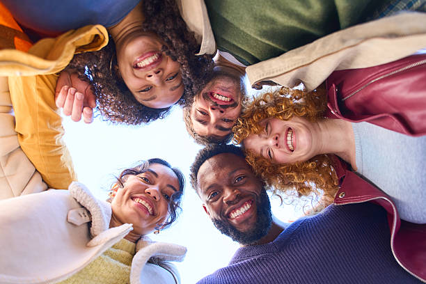istock Happy multi ethnic friends forming a circle and smiling 2213164596