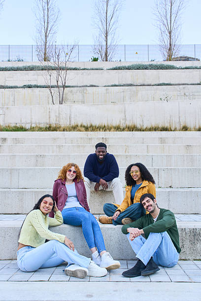istock Group of students relaxing together on university campus stairs 2213164660