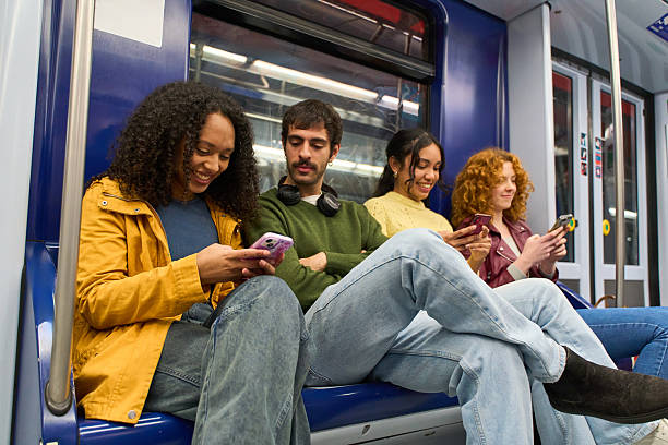 istock Young people using smartphones on subway train 2213166205