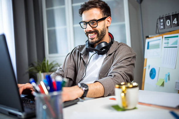 istock Young man working from home with headphones around his neck. 2213166496
