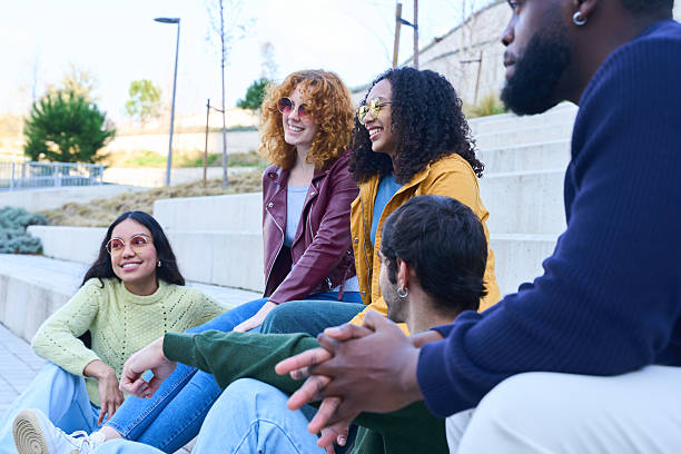 istock Group of diverse students relaxing and chatting on campus steps 2213166524