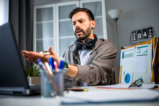 istock Young man working on his laptop with a coffee mug in hand. 2213166688