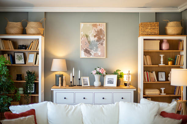 Stylish and cozy living room interior with bookshelves, a comfortable sofa, and decorative elements, creating a welcoming atmosphere