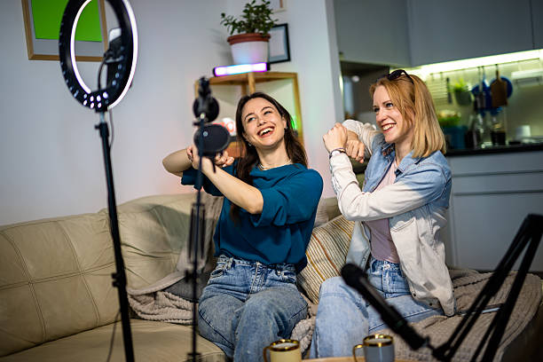 istock Creative teamwork: women recording a podcast in a cozy home setting. 2213173719