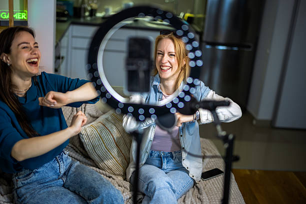 istock Creative teamwork: women recording a podcast in a cozy home setting. 2213173743
